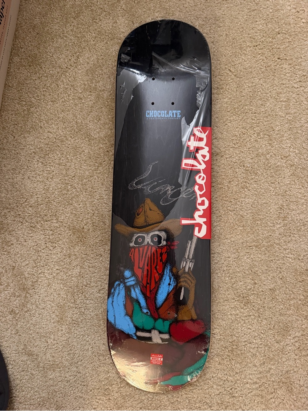 Chocolate Black Skateboard Deck with Red and Blue Cowboy Graphic